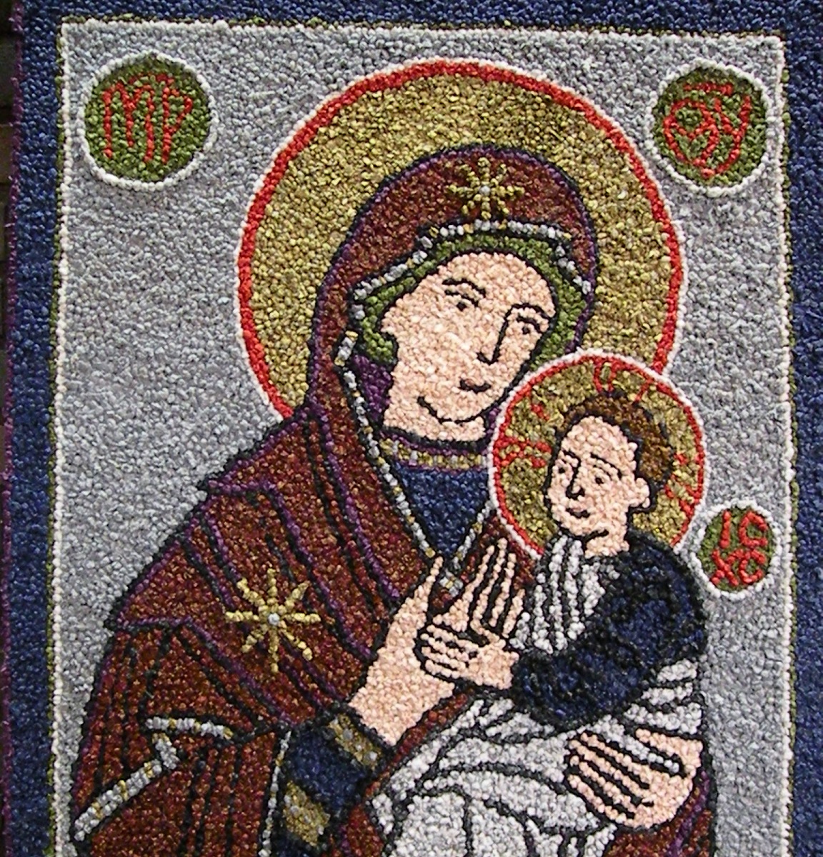 Maria sylissään Jeesus-lapsi